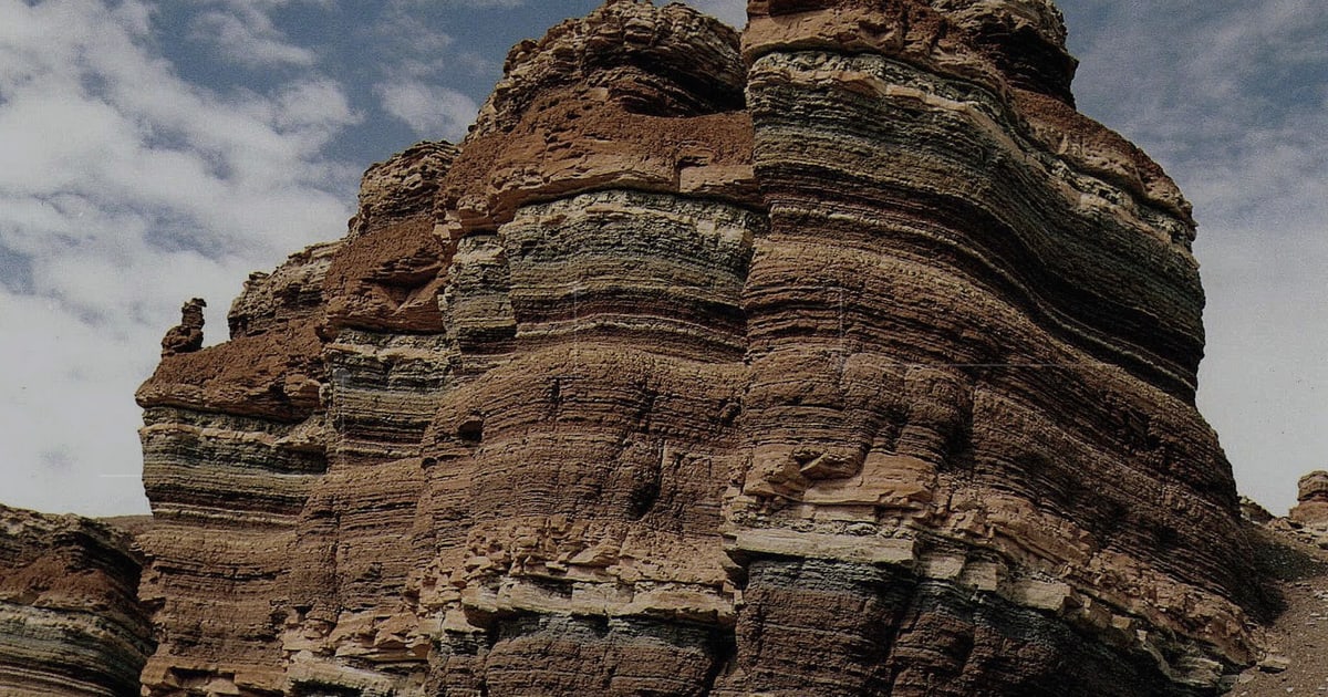 Layered rock formation used as a symbol for accumulated engineering history.